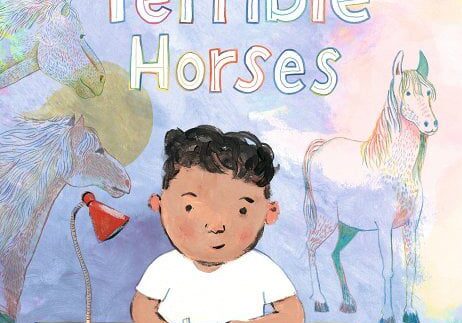 A boy is sitting at a table with a horse.